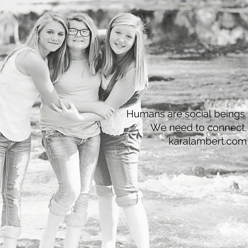 Three girls are posing for a photo to put the social in social media.