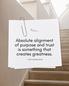 A notecard clipped to a staircase displays the quote: "Absolute alignment of purpose and trust is something that creates greatness," a concept often explored in finding true synergy, as noted by Jeff Sutherland.